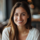 Femme souriante en intérieur, ambiance chaleureuse